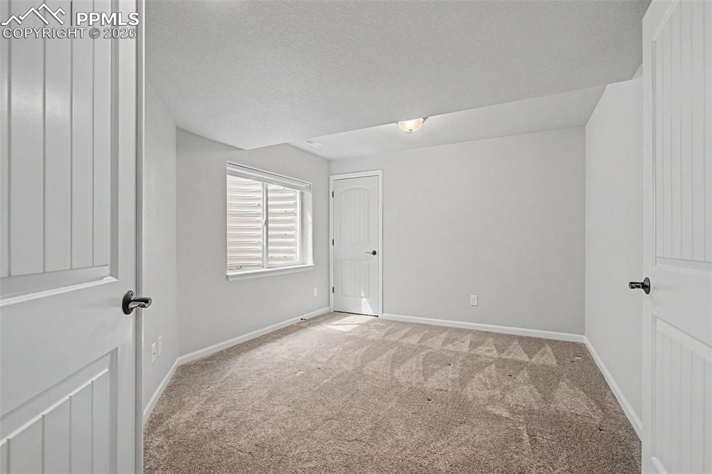 4467 Hessite Loop Colorado Springs, CO 80938 - Photo 29 of 37 a view of an empty room with a window