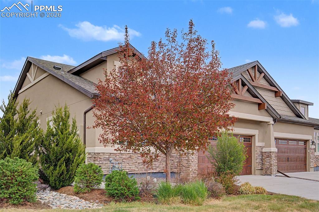 4467 Hessite Loop Colorado Springs, CO 80938 - Photo 4 of 37 a front view of a house with garden