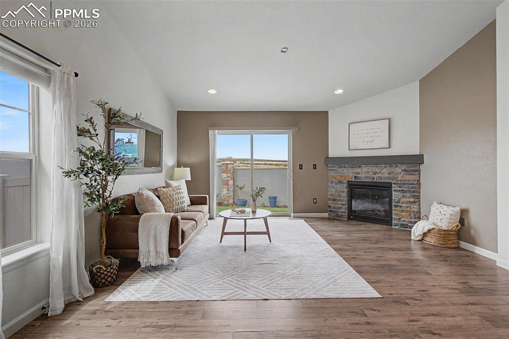 4467 Hessite Loop Colorado Springs, CO 80938 - Photo 5 of 37 a living room with furniture and a fireplace