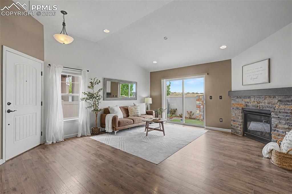 4467 Hessite Loop Colorado Springs, CO 80938 - Photo 6 of 37 a living room with furniture and a fireplace