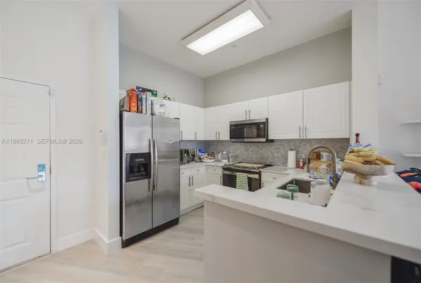 a kitchen with a sink a stove and cabinets