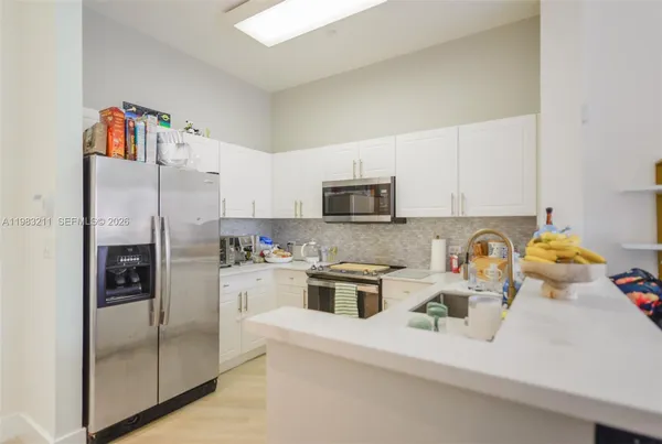 a kitchen with a sink stove and cabinets