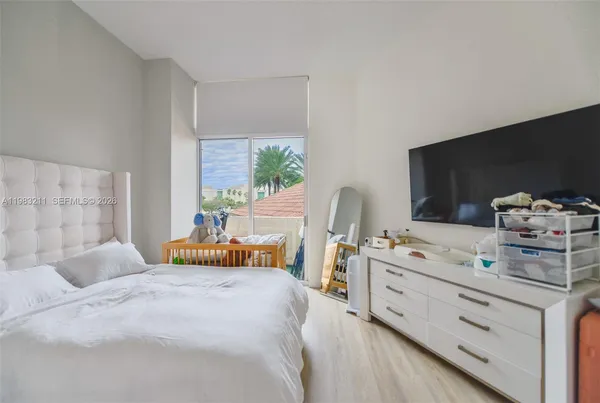 a bedroom with a bed and a large window