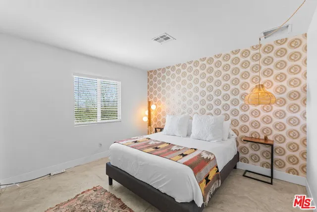 a bedroom with a bed and a mirror