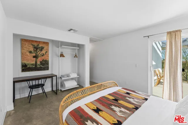 a bedroom with furniture and a window