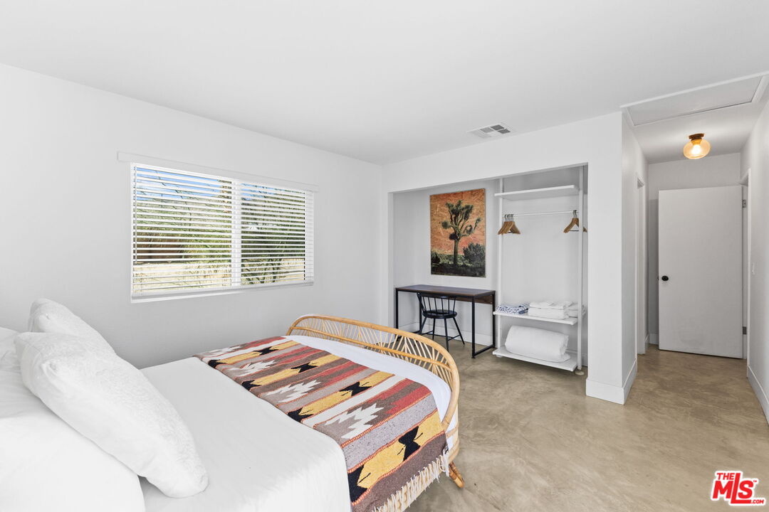 4789 Avenida Del Sol Joshua Tree, CA 92252 - Photo 15 of 37 a bedroom with furniture and a window