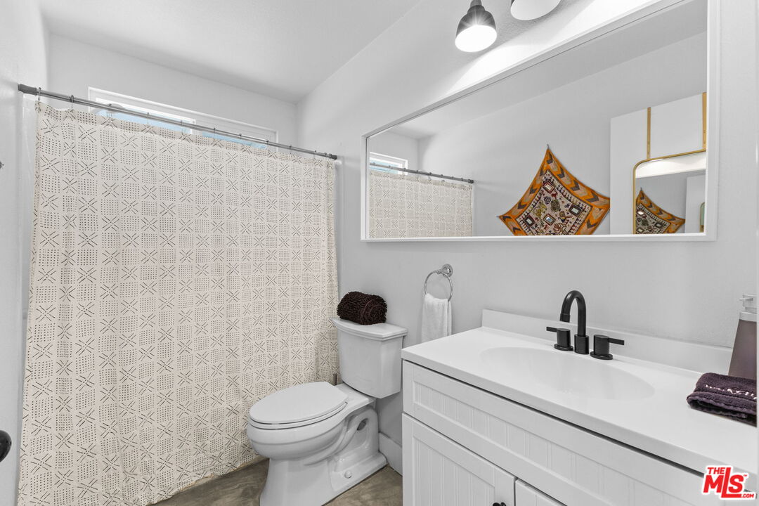 4789 Avenida Del Sol Joshua Tree, CA 92252 - Photo 16 of 37 a bathroom with a toilet sink and mirror