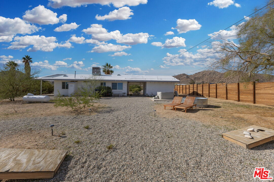 4789 Avenida Del Sol Joshua Tree, CA 92252 - Photo 32 of 37 a view of a house with a yard