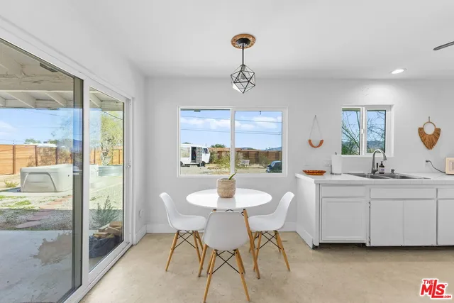 a dining room with furniture and window