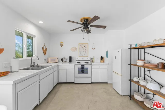 a kitchen with cabinets a sink and appliances