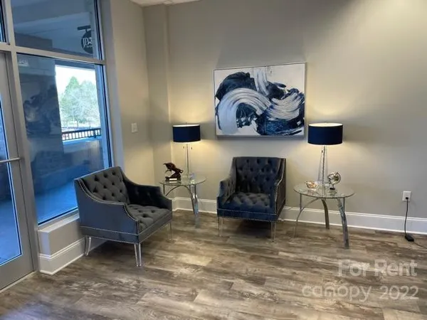 a living room with furniture and a lamp