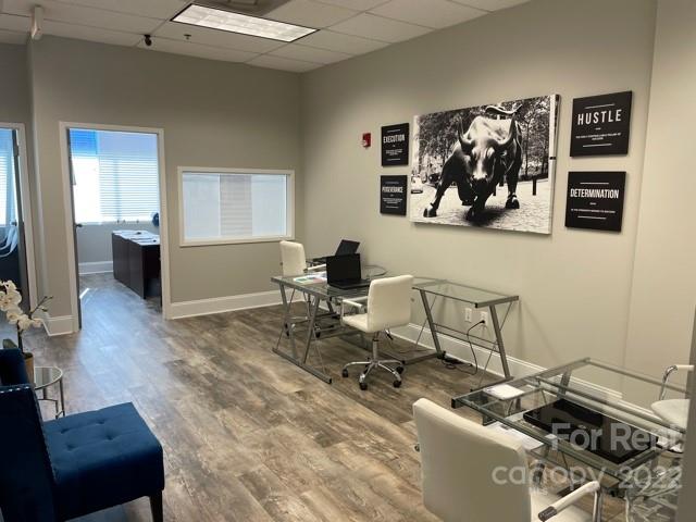 7510 Pineville-Matthews Road, Unit 14B Charlotte, NC 28226 - Photo 7 of 14 a living room with a couch and a dresser with wooden floor