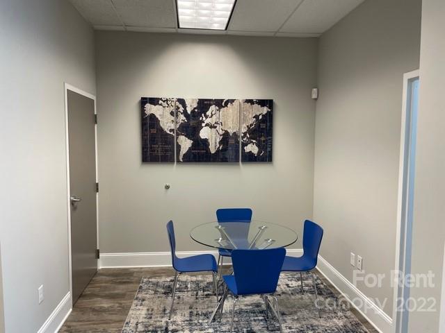 7510 Pineville-Matthews Road, Unit 14B Charlotte, NC 28226 - Photo 9 of 14 a view of dining room with furniture and wooden floor