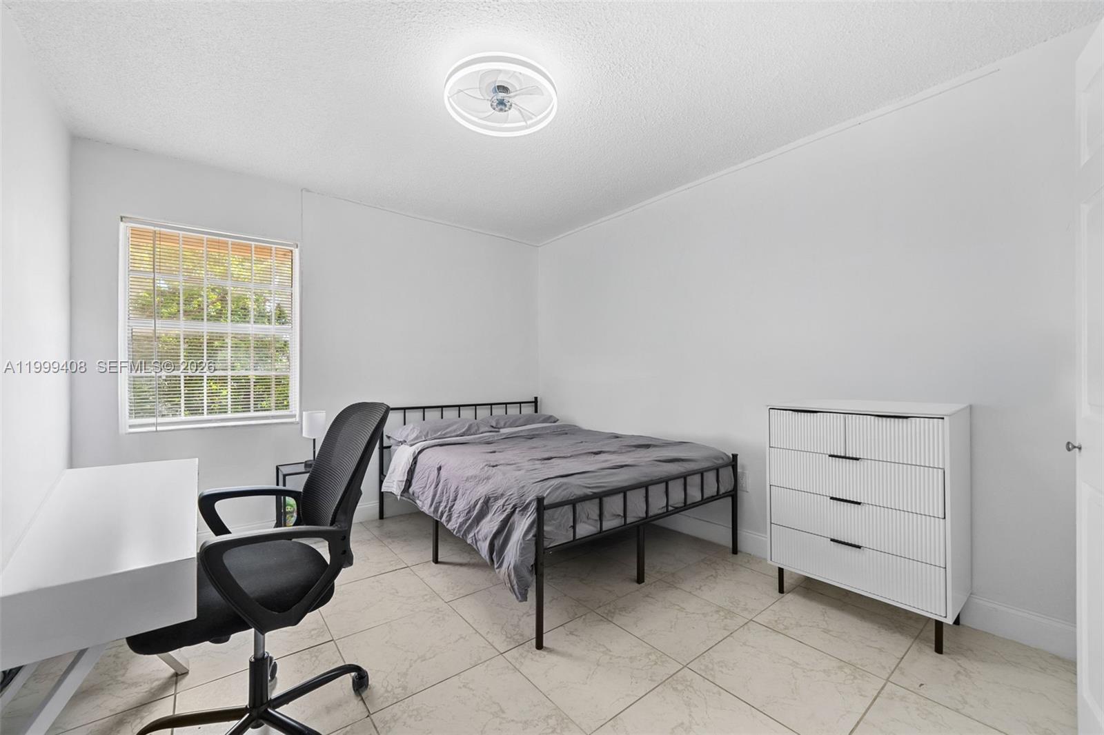 515 Southwest 3rd Street, Unit 6 Miami, FL 33130 - Photo 7 of 19 a bedroom with a bed and chair with a mirror
