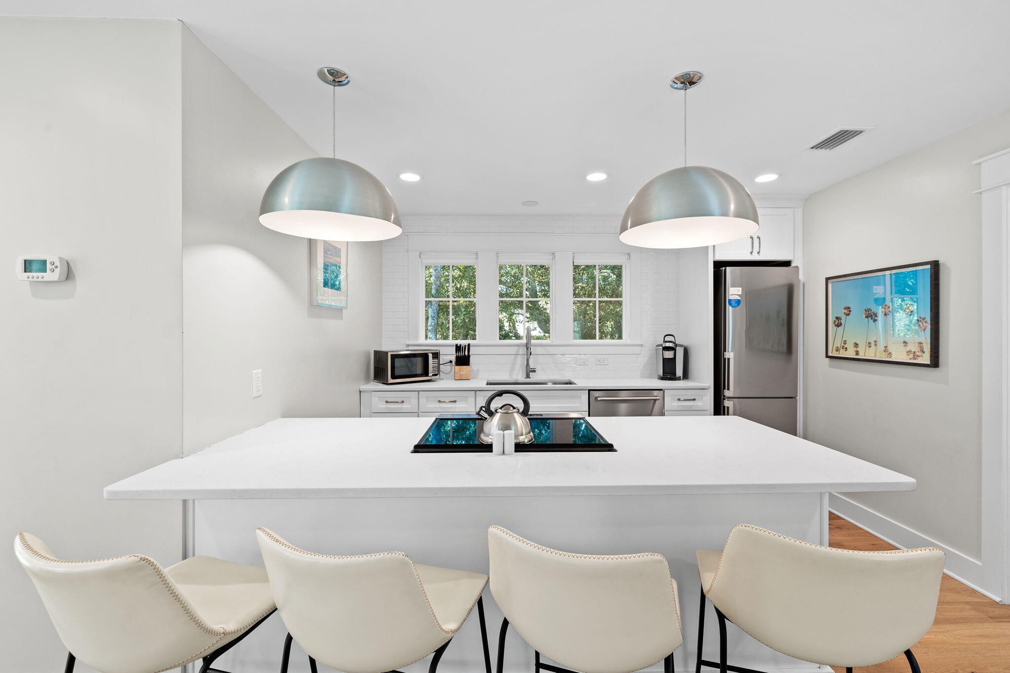 6312 West County Highway 30A Santa Rosa Beach, FL 32459 - Photo 42 of 58 a view of a dining room with furniture a chandelier and wooden floor