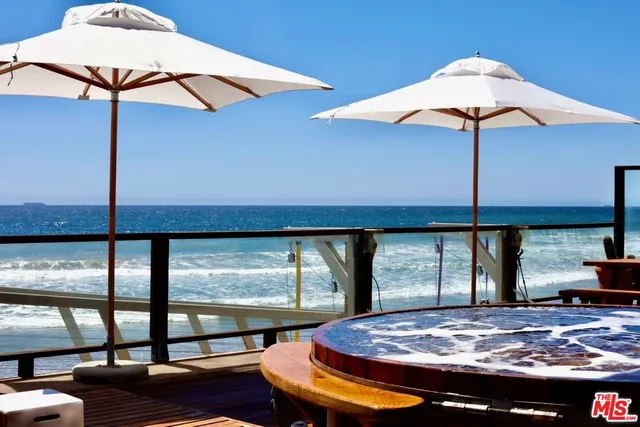 a bedroom with two beds and a large window