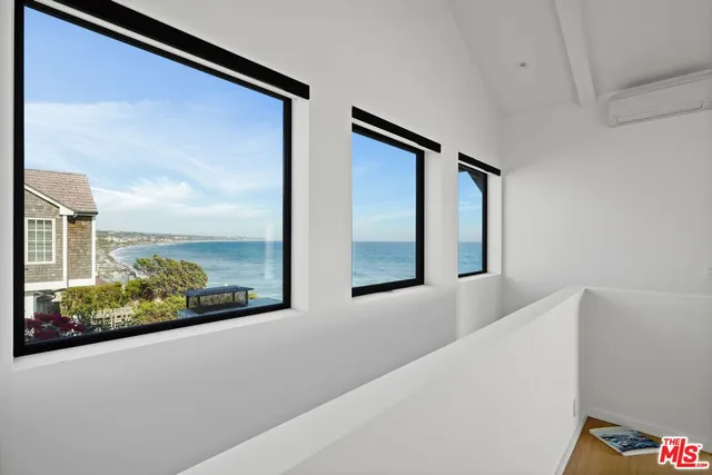 a bathroom with a glass shower door and a window