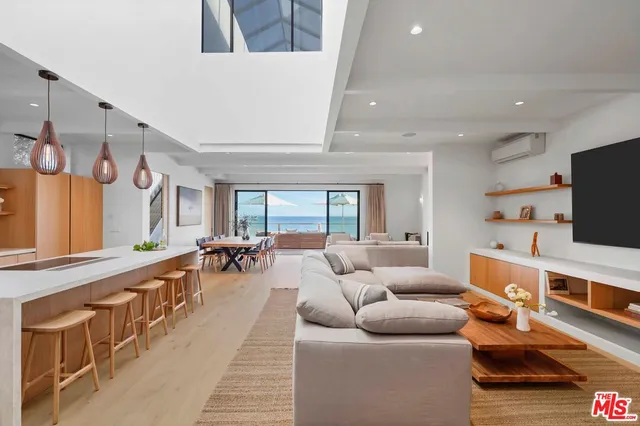 a living room with furniture and kitchen view