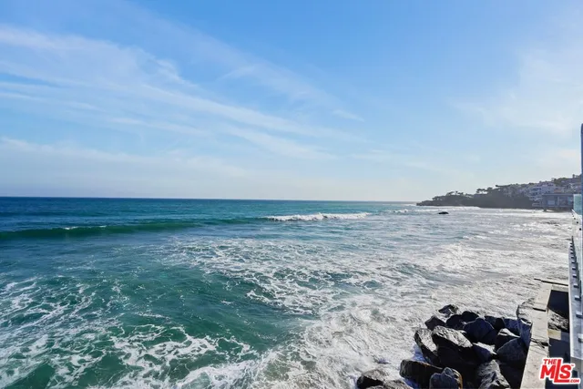 a bathroom with a double vanity sink a toilet and a large mirror