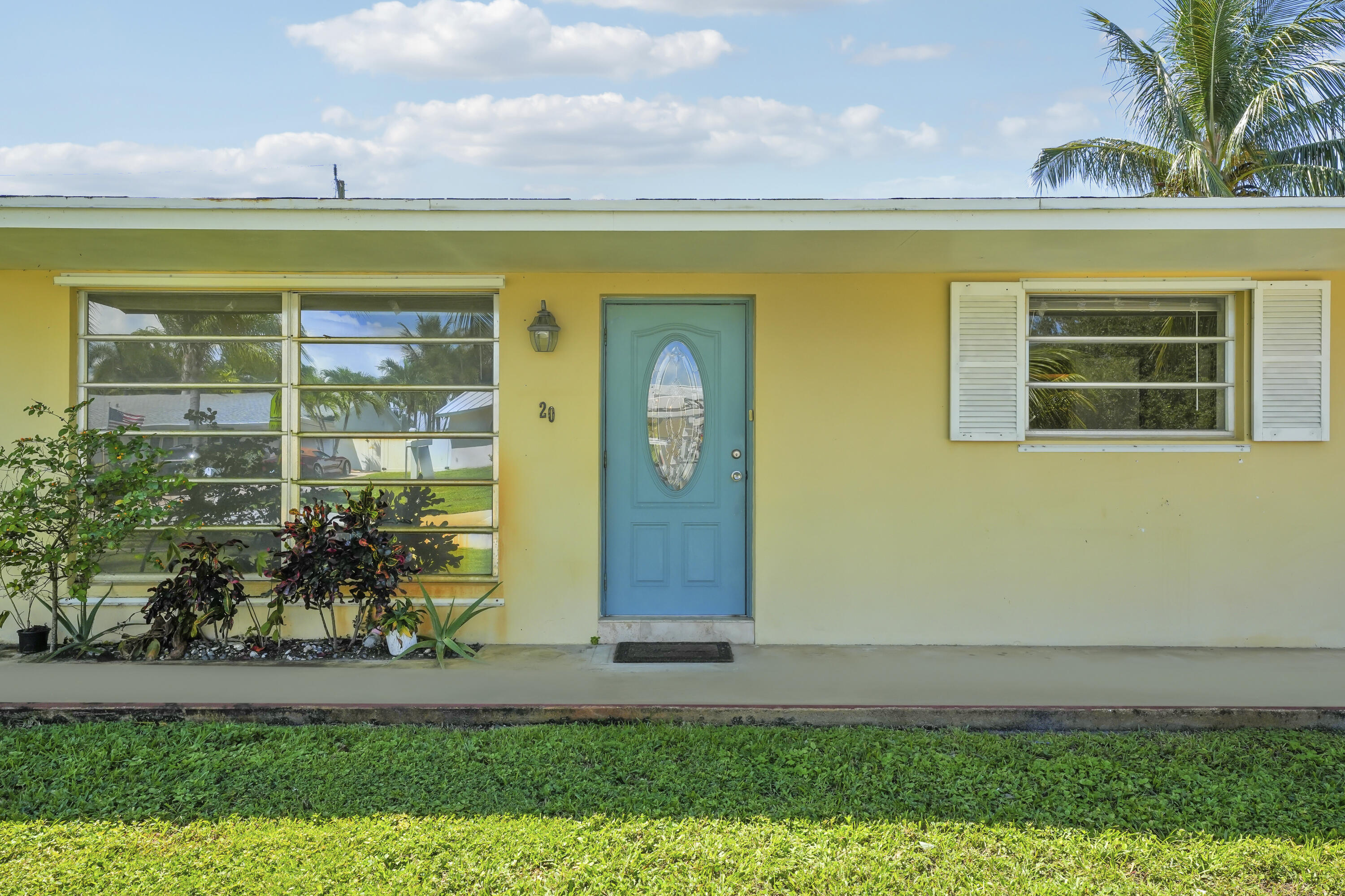 20 Willow Road Tequesta, FL 33469 - Photo 13 of 43 a view of a brick house with a yard