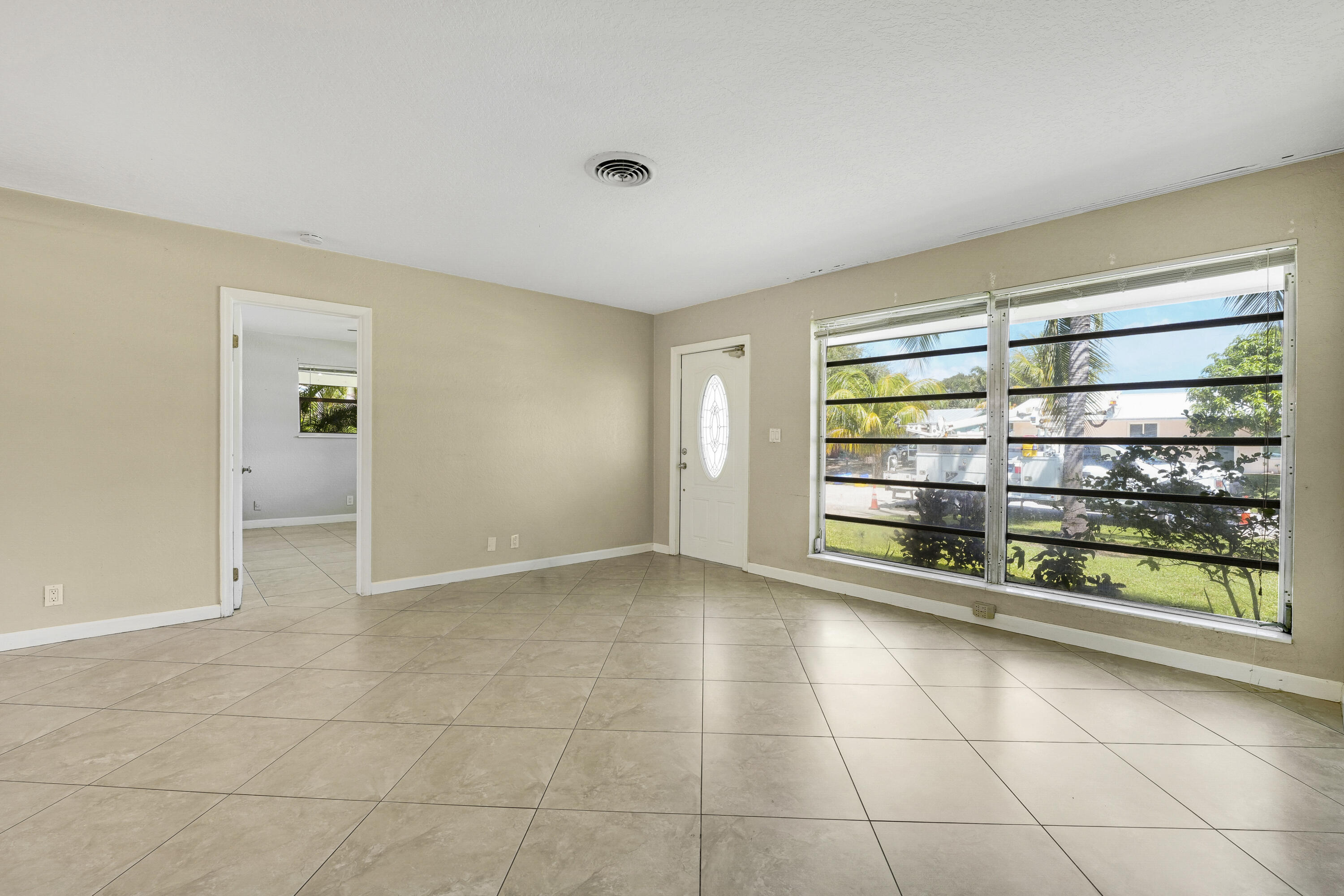 20 Willow Road Tequesta, FL 33469 - Photo 16 of 43 a view of room with window and refrigerator