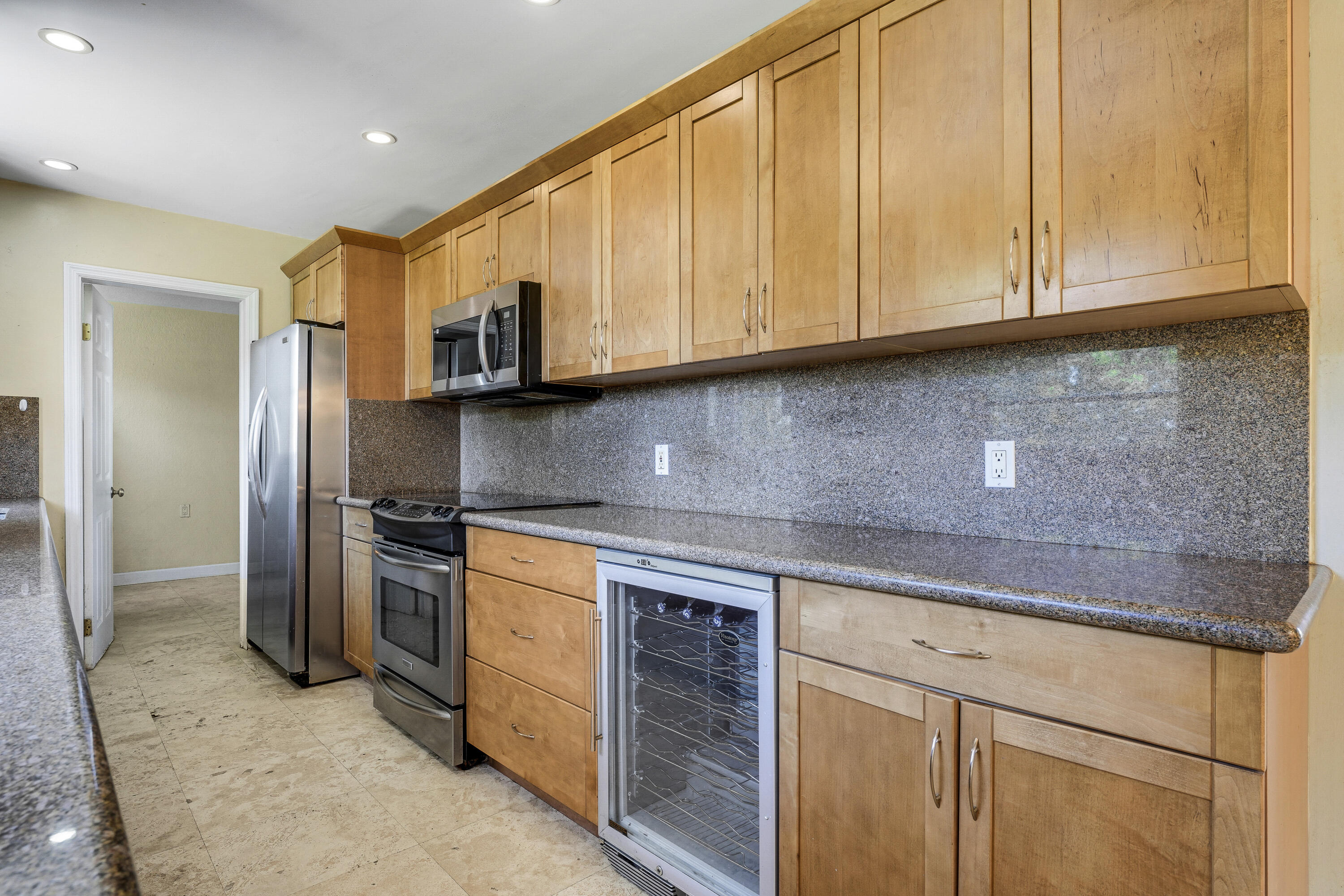 20 Willow Road Tequesta, FL 33469 - Photo 20 of 43 a kitchen with stainless steel appliances granite countertop a sink a stove and a refrigerator