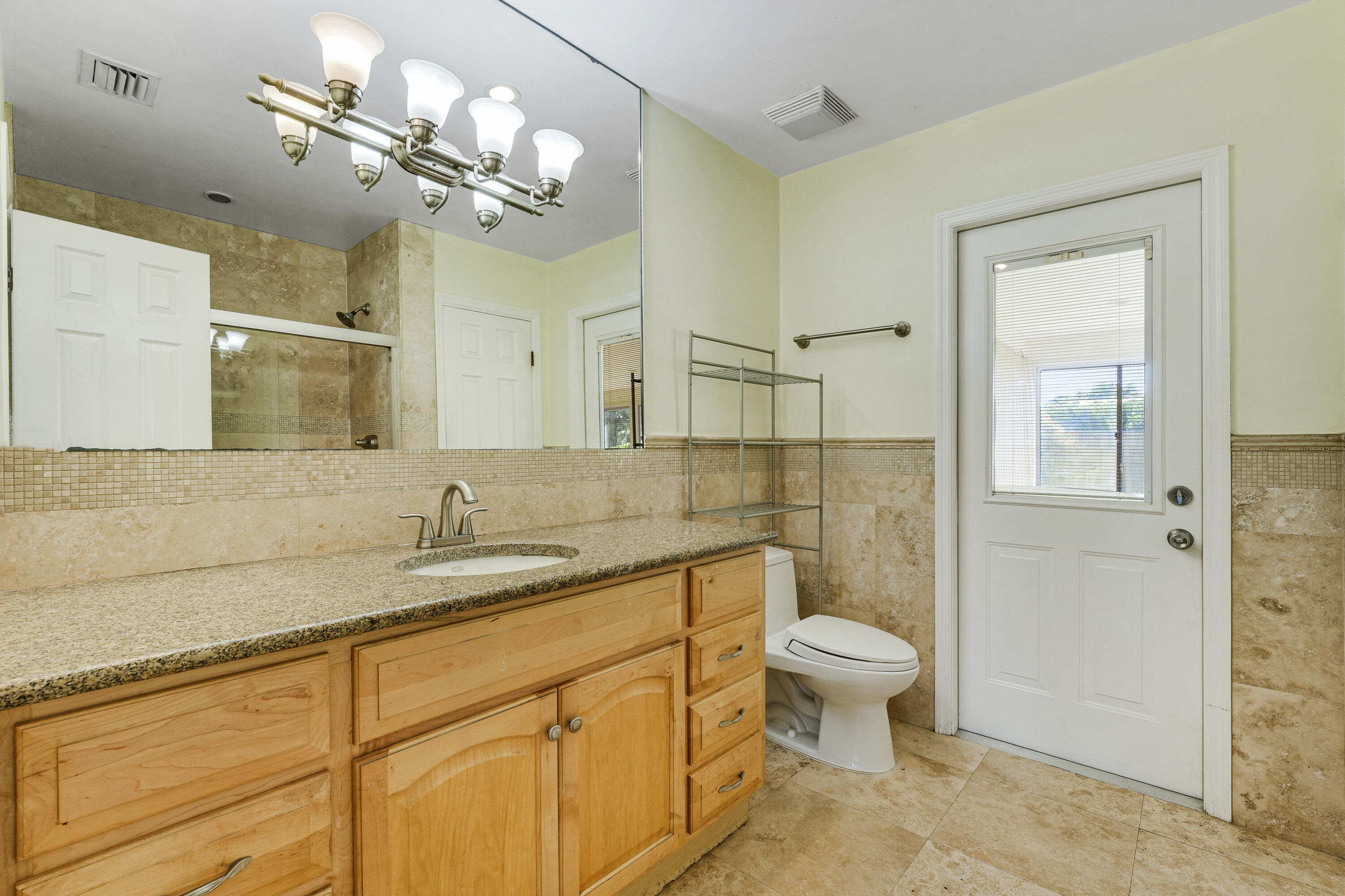 20 Willow Road Tequesta, FL 33469 - Photo 29 of 43 a bathroom with a toilet sink and mirror