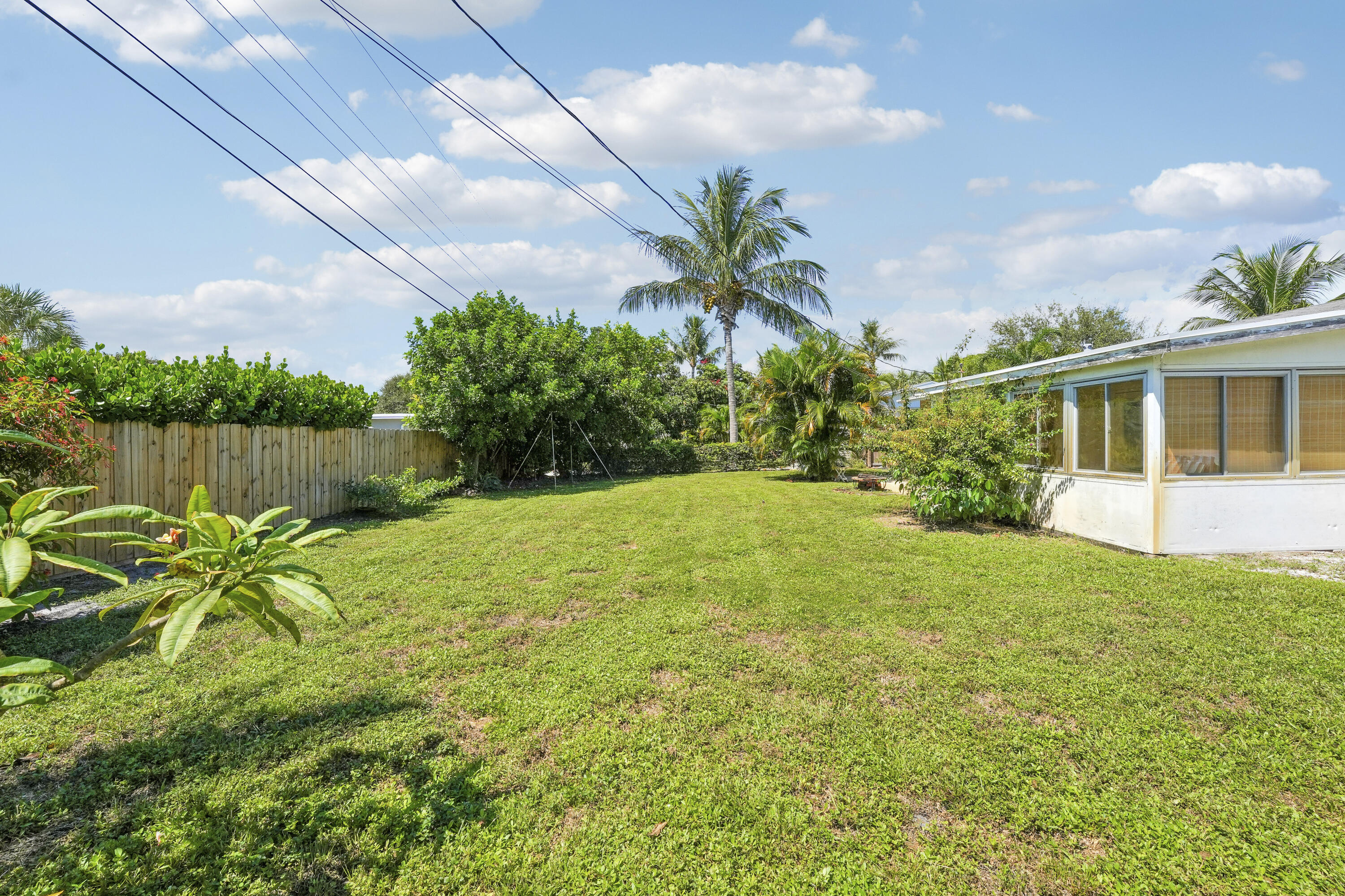 20 Willow Road Tequesta, FL 33469 - Photo 35 of 43 a view of a backyard with a garden