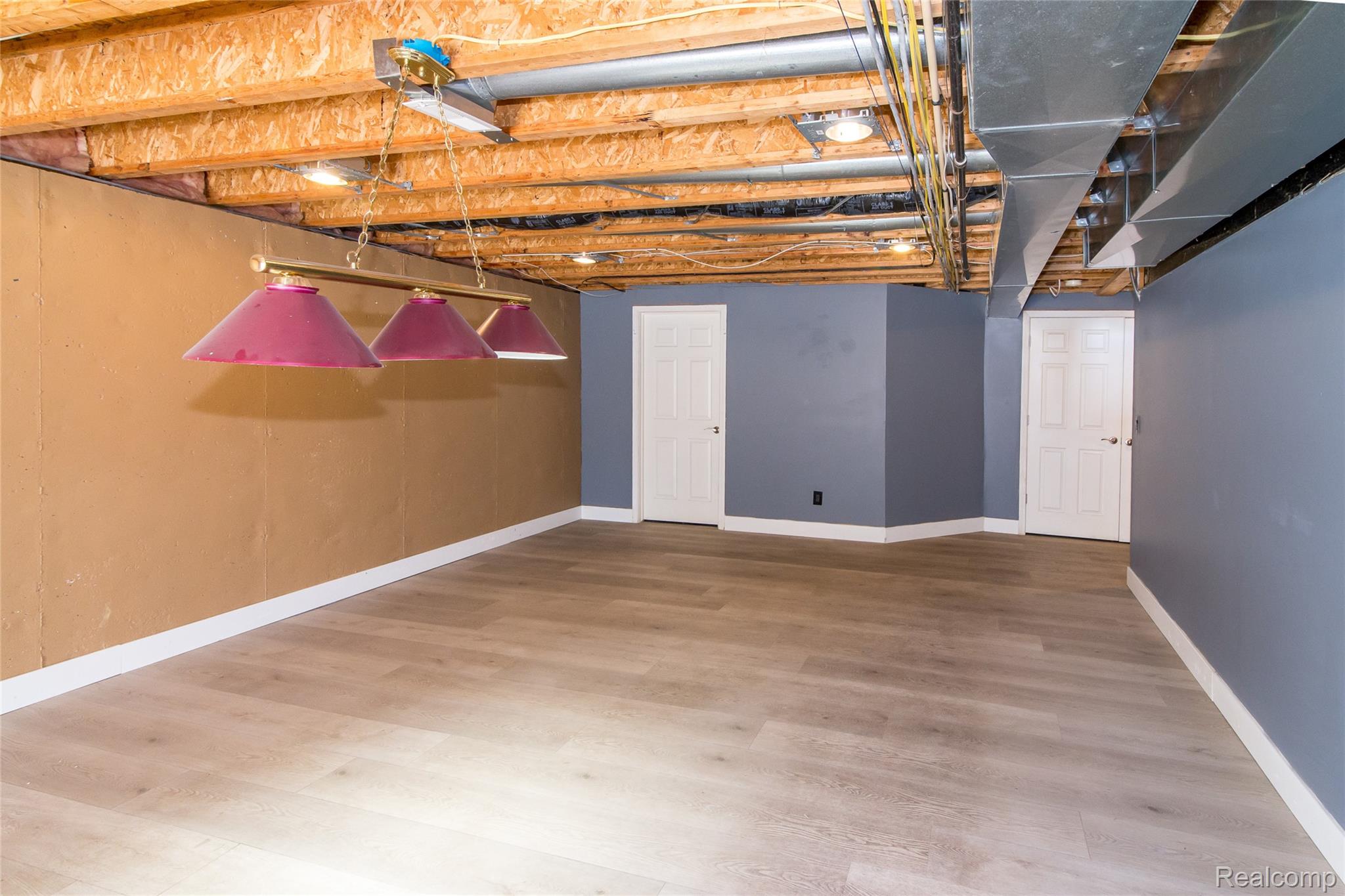 486 Sweet Briar Ridge Linden, MI 48451 - Photo 59 of 69 Wood-finish flooring, recessed lighting, and a multi-shade pendant light fixture