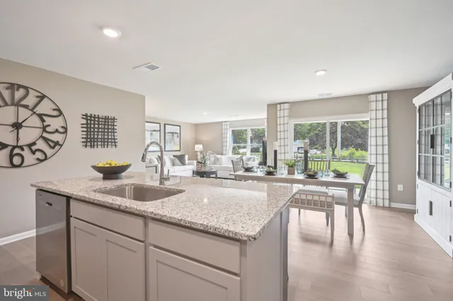 a view of living room with granite countertop furniture and wooden floor