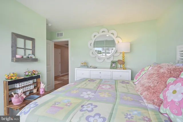 a bedroom with a bed and a dresser in it