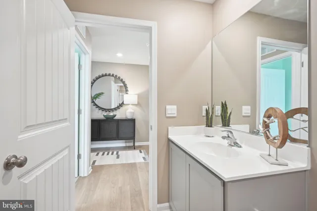 a bathroom with a double vanity sink mirror and bathtub