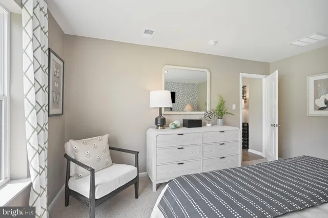 a bedroom with a bed and a dresser