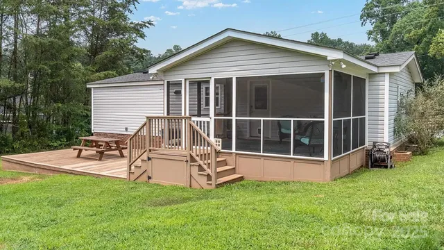a view of a house with a yard and sitting area
