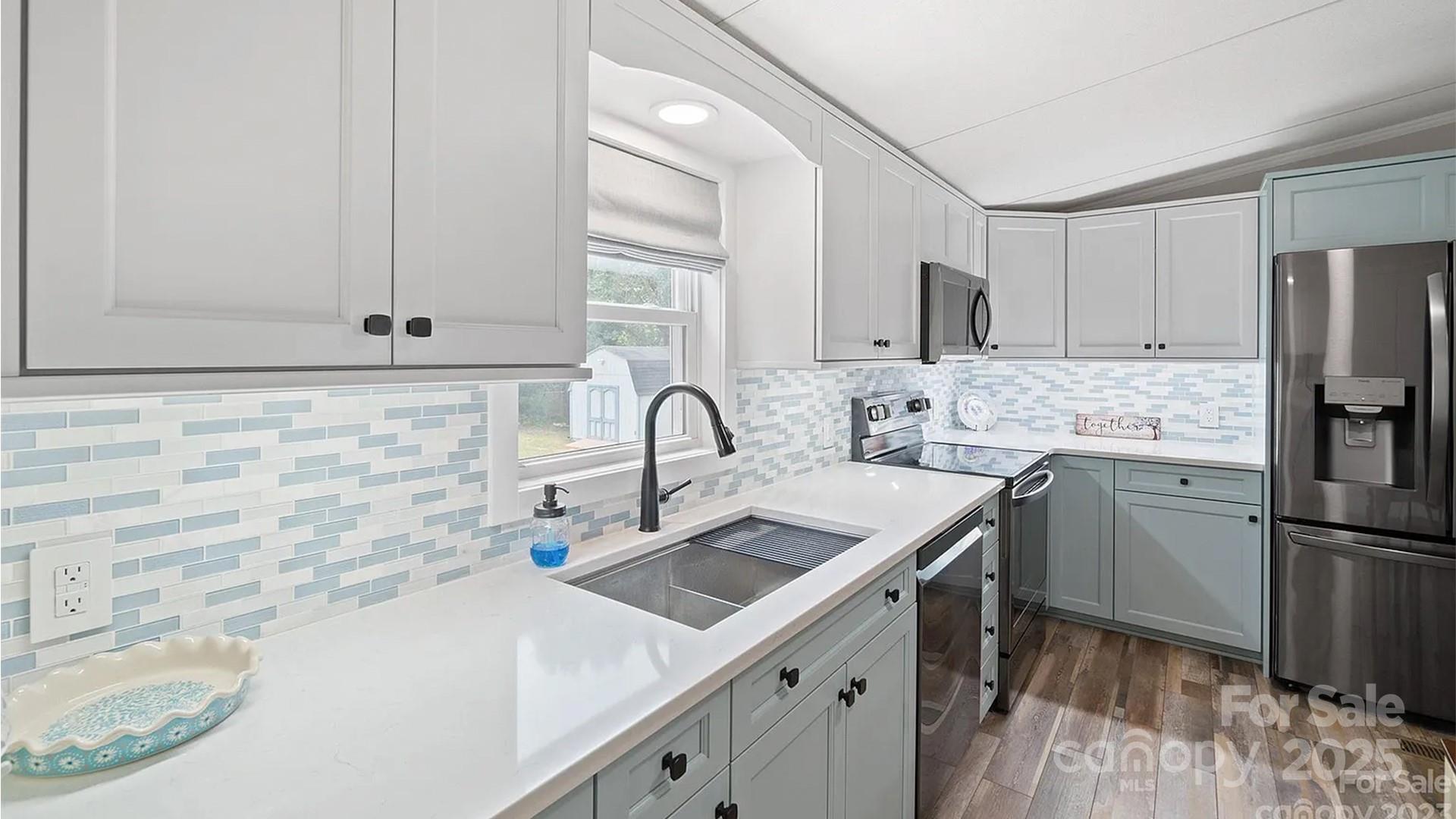 4220 Mt Beulah Road Maiden, NC 28650 - Photo 6 of 13 a kitchen with stainless steel appliances a sink a stove and a refrigerator