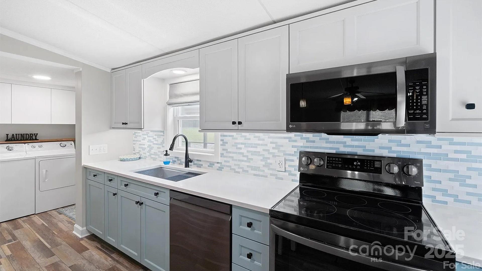 4220 Mt Beulah Road Maiden, NC 28650 - Photo 7 of 13 a kitchen with a sink stove and cabinets