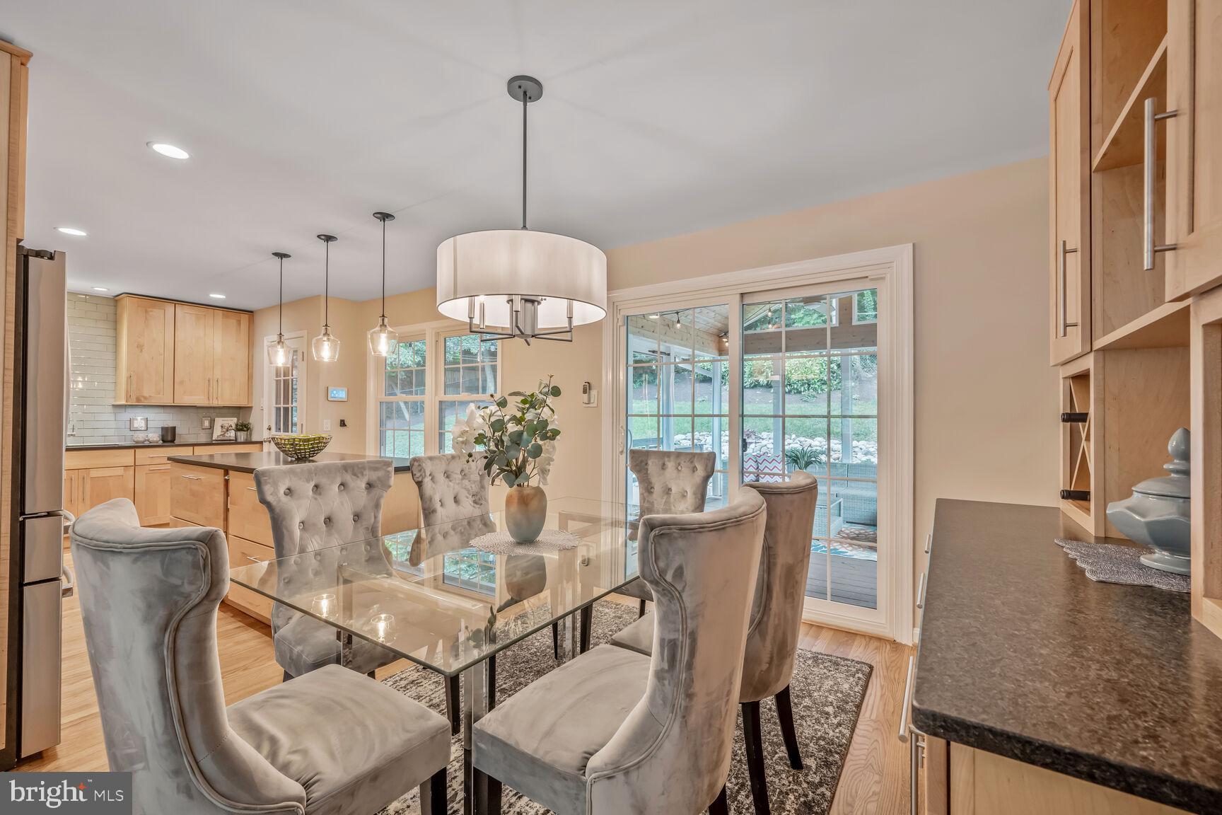 10412 Kinloch Road Silver Spring, MD 20903 - Photo 7 of 37 a view of a dining room with furniture a chandelier and wooden floor