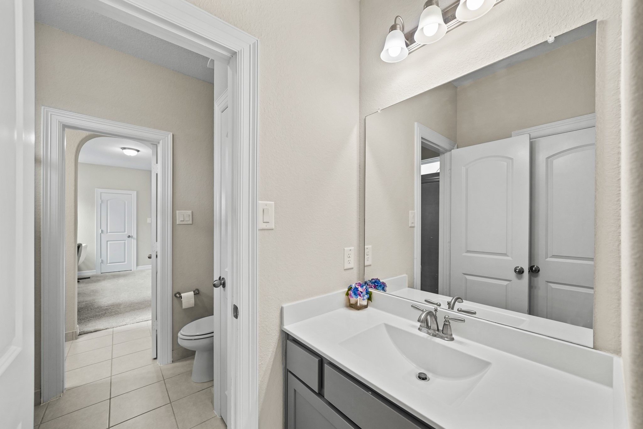 24031 Corinaldo Court Katy, TX 77493 - Photo 17 of 23 a bathroom with a sink vanity and a mirror