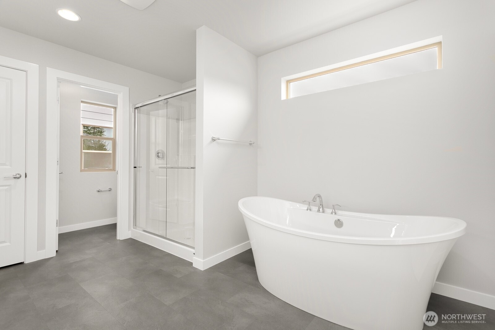 13302 Southeast 238th Place, Unit 7 Kent, WA 98042 - Photo 33 of 37 a white bath tub sitting in a bathroom