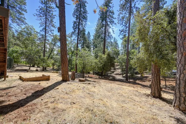 a view of a house with a deck and a yard