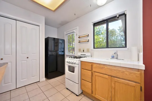 a view of a small house with backyard