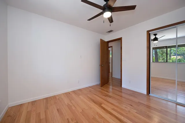 a bathroom with a granite countertop sink a mirror and a shower