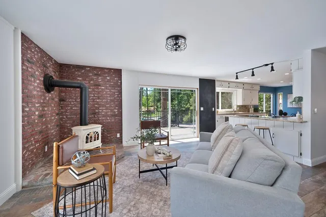a living room with furniture and a floor to ceiling window