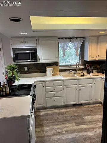 a kitchen with stainless steel appliances a stove sink and cabinets