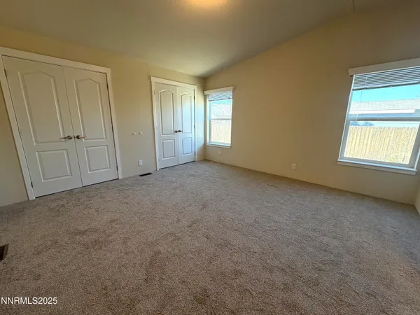 a view of an empty room with windows