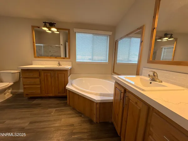 a bathroom with a tub sink and mirror