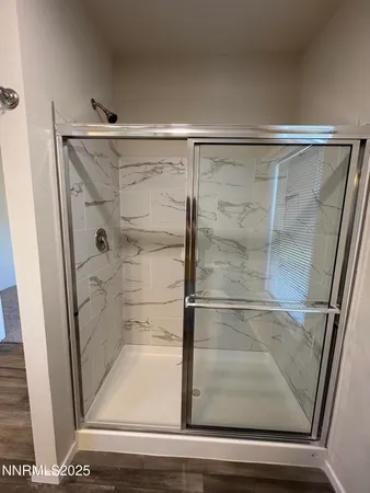 a bathroom with a glass shower door