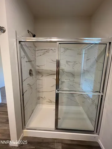 a bathroom with a glass shower door