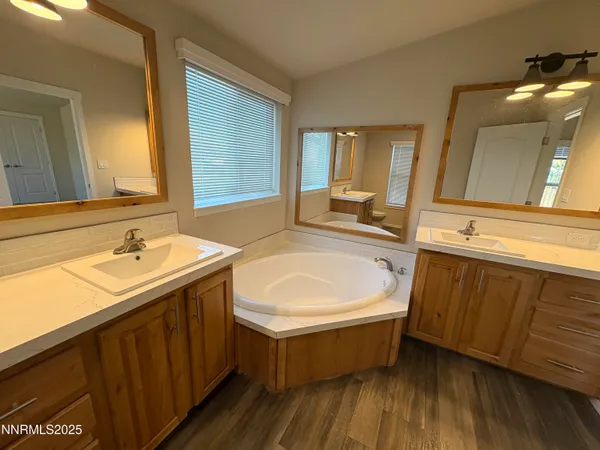 a bathroom with a double vanity sink and mirror