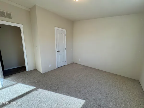 a view of an empty room and entryway